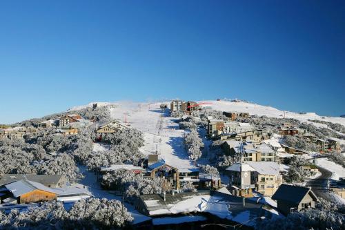 a town on top of a snow covered mountain at On mountain apartment Twin Towers 304B in Mount Buller