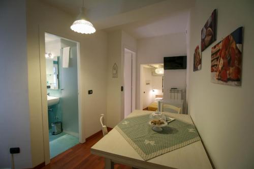 a kitchen with a table and a room with a hallway at Casa Chiasso Cacace in Monopoli