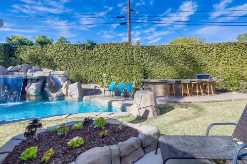 a backyard pool with a waterfall and a table and chairs at Beautiful Backyard Oasis 5 bedroom 3 Bathroom Home in Placentia
