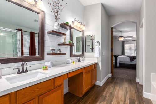 a bathroom with two sinks and two mirrors at Harrison Chandler in Chandler