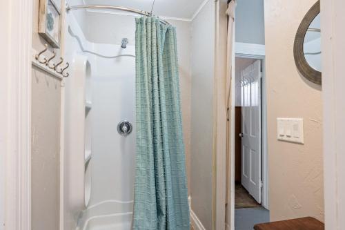 a bathroom with a shower curtain in a hallway at Dual Unit Mountain Retreat, 4BR, Prime Location, Sleeps 10, Historic Charm & Modern Luxury, Steps to Main St! in Park City