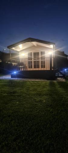 a building lit up at night with lights in the grass at Casa vieira in Bico