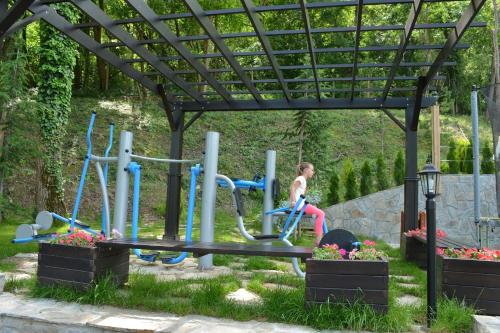 a girl on a playground in a park at Park Hotel Asenevtsi in Veliko Tŭrnovo