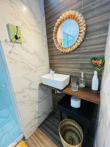 a bathroom with a sink and a mirror on the wall at Loft Casa do Tamarineiro in Salvador