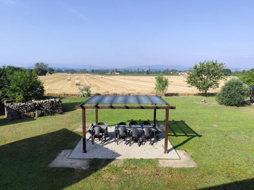 a group of chairs under a gazebo in a field at Casa del Contadino in Sansepolcro