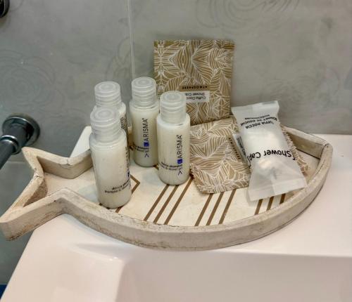 a counter with four bottles of soap and a bag of toiletries at Bilocale Poseidonia in Favignana