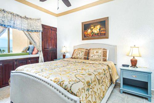 a bedroom with a bed with a painting on the wall at Princesa De Penasco in Punta Penasco New