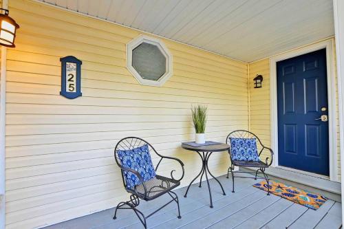 two chairs and a table on a porch with a blue door at Port royal road 25 in Ocean View