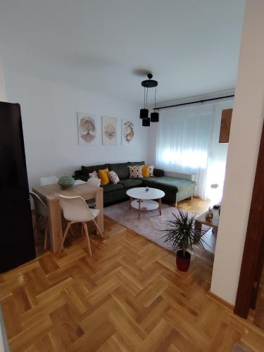 a living room with a couch and a table at Apartman Fenix in Pirot