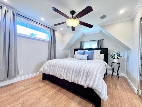 a bedroom with a bed with a ceiling fan at Cute 3 bedroom 2 bath home near Convention Center & Disney in Anaheim