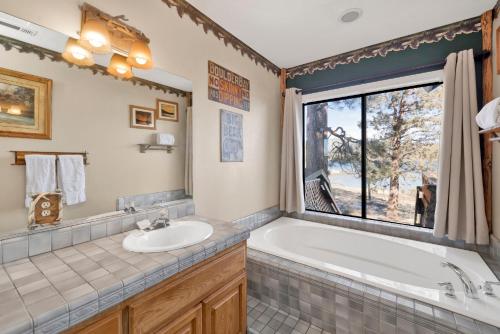 a bathroom with a tub and a sink and a window at Lake shore #012 in Big Bear Lake
