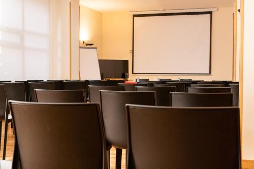 an empty room with chairs and a whiteboard at Pacoche Murcia in Murcia
