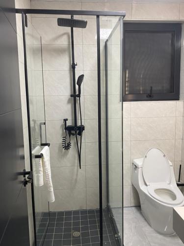 a bathroom with a shower with a toilet at 7th Heaven luxury Apartment in Gaborone