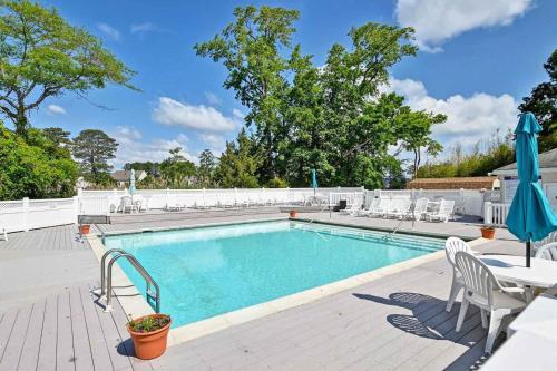 a swimming pool with chairs and a table and an umbrella at Port royal road 25 in Ocean View