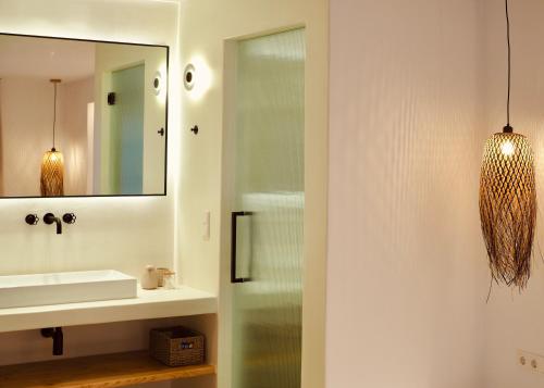 a bathroom with a sink and a mirror at Ayana in Naxos Chora