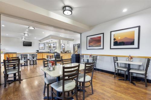 ウッドバーンにあるBest Western Woodburn Innのテーブルと椅子とバーのあるレストラン
