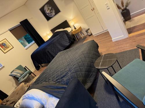 a bedroom with a bed and a couch at Serengeti & Stayover in Svebølle