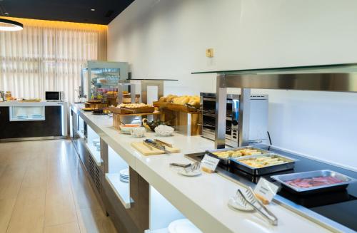 a kitchen with a buffet of food on a counter at Pacoche Murcia in Murcia
