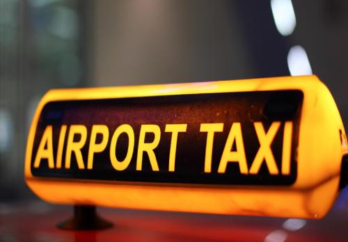a sign that says airport taxi on a taxi at Hotel De Avlon Suites Near Delhi Airport in New Delhi