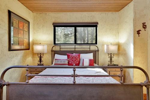 a bedroom with a bed with two lamps and a window at How sweet it is #1531 in Big Bear Lake