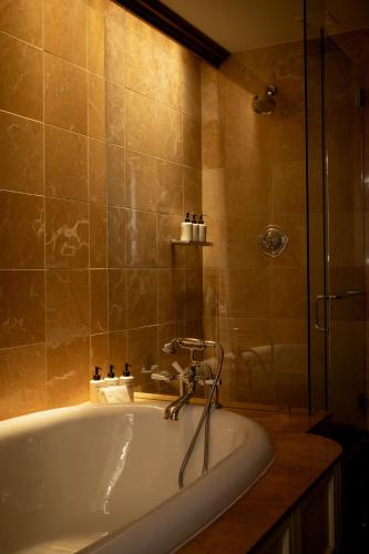 a bath tub in a bathroom with a shower at Four Seasons Resort Whistler in Whistler