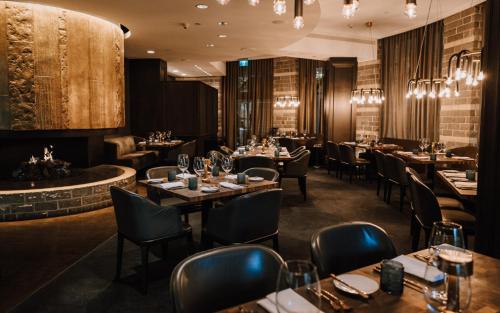 a restaurant with tables and chairs and a bar at Four Seasons Resort Whistler in Whistler