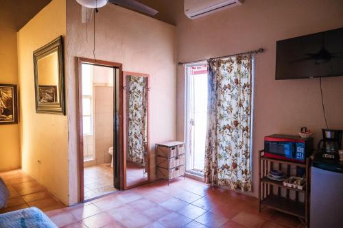 a living room with a large window and a door at Hacienda del Desierto in San Felipe