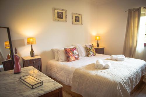 a bedroom with a bed with towels on it at Monte do Trancoso in Alvito