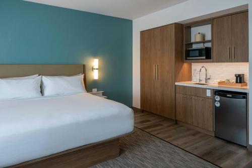 a hotel room with a bed and a kitchen at Element Carmel in Carmel