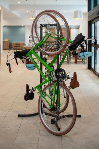 a green bike on a bike rack in a room at Element Carmel in Carmel