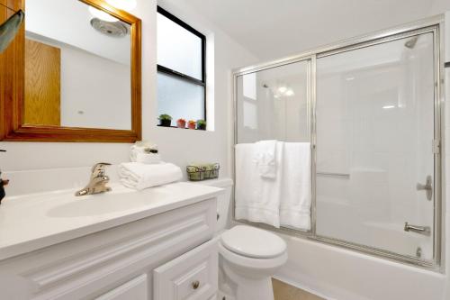 a white bathroom with a toilet and a shower at Bear meadow woods condo #2341 in Big Bear Lake