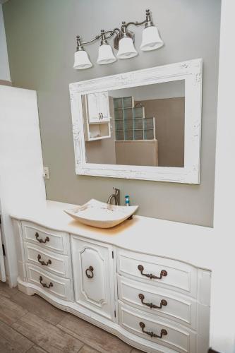 a bathroom with a sink and a mirror at Hacienda del Desierto in San Felipe
