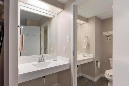 a bathroom with two sinks and a mirror at Center Parlor Room at Sandy Cove Unit in North East