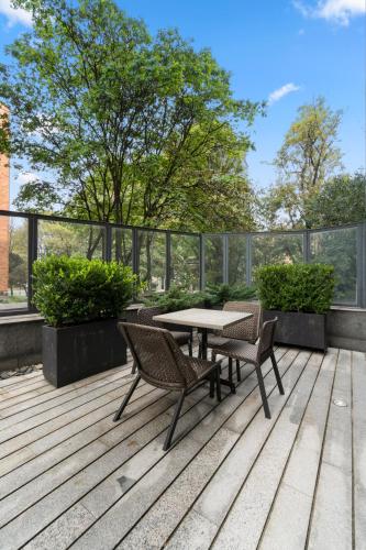 a patio with a table and chairs on a deck at BOG Hotel in Bogotá