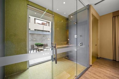 a glass corridor with a table and chairs in a room at BOG Hotel in Bogotá