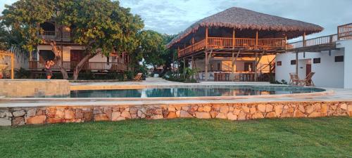 a swimming pool in a yard next to a building at Pousada Villa Tibá in Jericoacoara