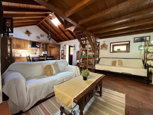 a living room with a couch and a table at Casa terrera "El Granero" in Tanque