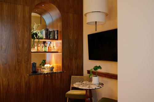 a living room with a table and a mirror at Municipal Grand in Savannah
