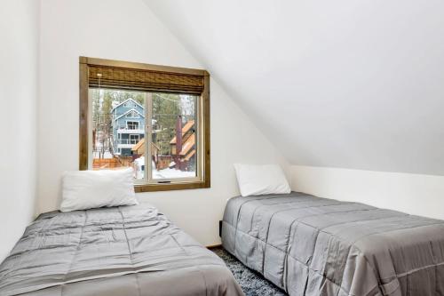 a bedroom with two beds and a window at Village chic chalet #2113 in Big Bear Lake