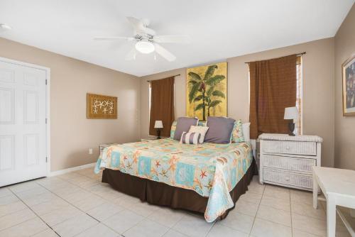 a bedroom with a bed and a ceiling fan at Palma Verde - Pet Friendly! in Mustang Beach