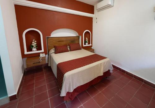 Postel nebo postele na pokoji v ubytování Hotel Encino Malecón Centro Puerto Vallarta