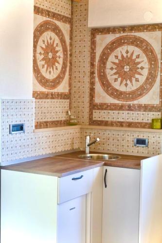 a kitchen with white cabinets and a sink at GV - Holiday home with MagnaPool in Makarska