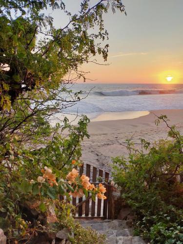 a view of the beach at sunset at Oceanfront cabin in Playa Mermejita Mazunte in Mazunte