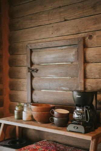 a counter with a coffee maker and bowls on it at Oceanfront cabin in Playa Mermejita Mazunte in Mazunte