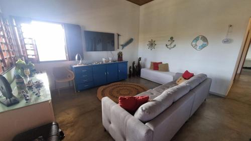 a living room with a couch and a table at Casa obster barrinha in Barra Grande