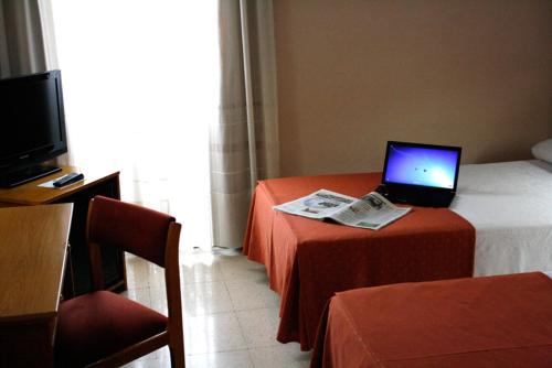 a hotel room with a laptop on a table at Pacoche Murcia in Murcia