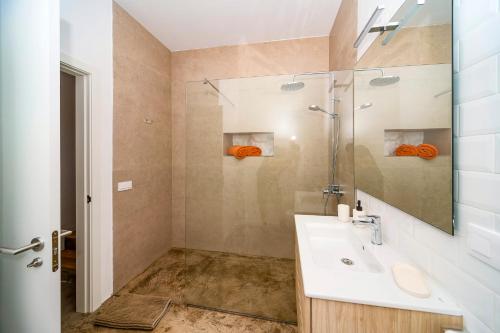 a bathroom with a sink and a mirror at Luxury House La Maison II in Tías