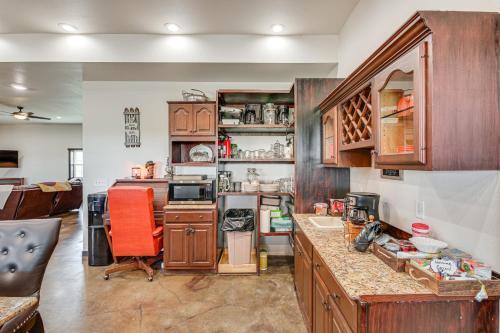 a kitchen with wooden cabinets and orange chairs in it at Pet Friendly Daydreamers Guest Ranch on 60 Acres in Lingle