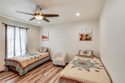 a bedroom with two beds and a ceiling fan at Pet Friendly Daydreamers Guest Ranch on 60 Acres in Lingle