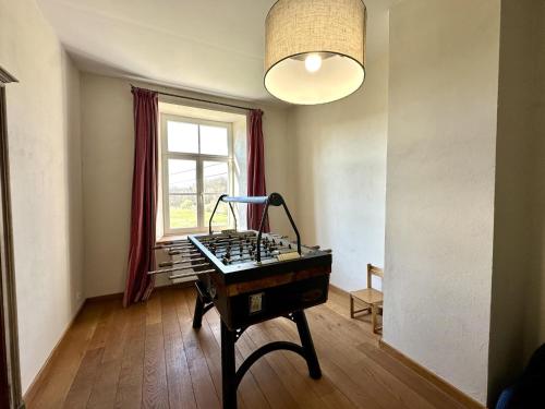 a room with a desk in a room with a window at Les Forges dOrval in Abbaye dʼOrval